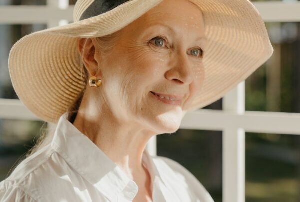 Donna matura serena con cappello di paglia, luce naturale